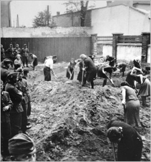 German troops look on as a group of Jewish women are foced to dig ditches in Krakow